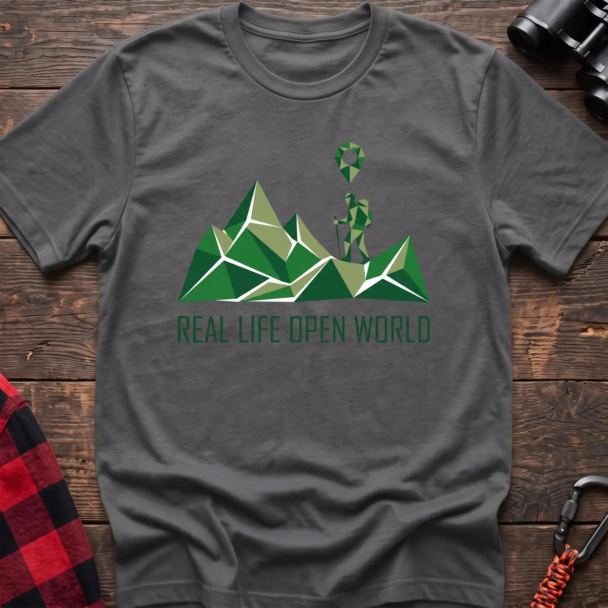 Graphite heather t-shirt with geometric green mountain graphic and a hiker silhouette under a map pin, reading Real Life Open World