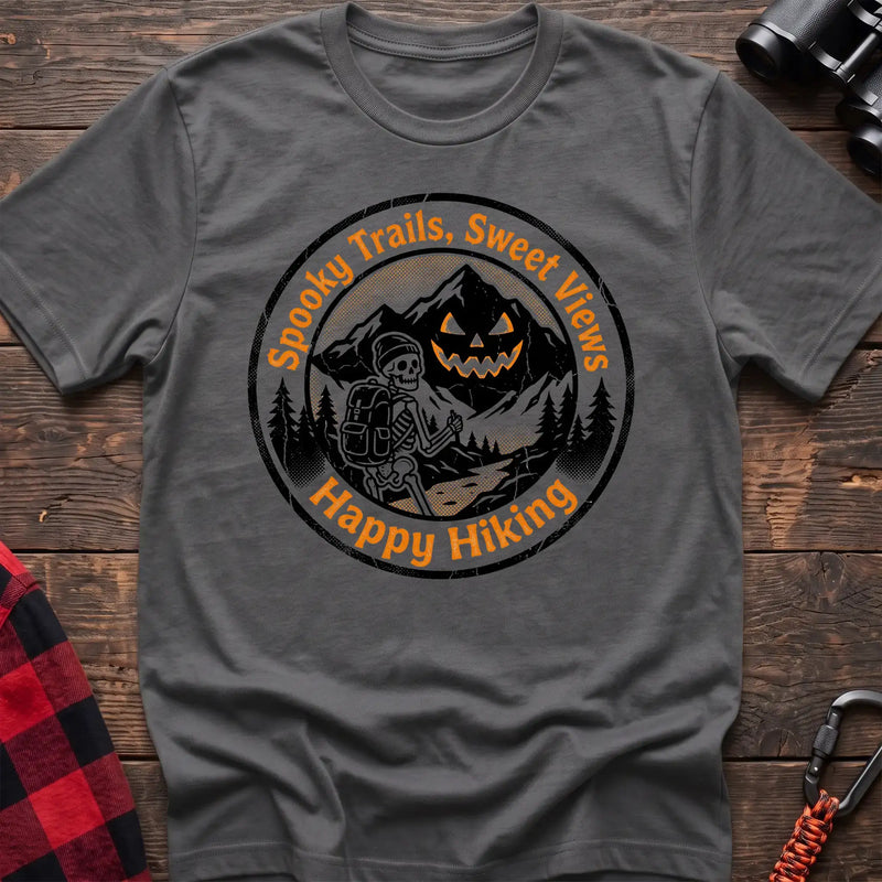 Graphite heather t-shirt with circular graphic of a skeleton hiker giving a thumbs up in front of a jack-o-lantern mountain, reading Spooky Trails Sweet Views Happy Hiking
