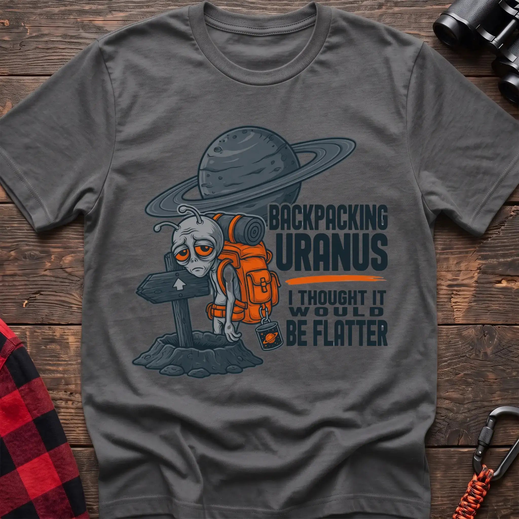 Graphite heather t-shirt with tired alien backpacker next to a trail sign and the text Backpacking Uranus I Thought It Would Be Flatter