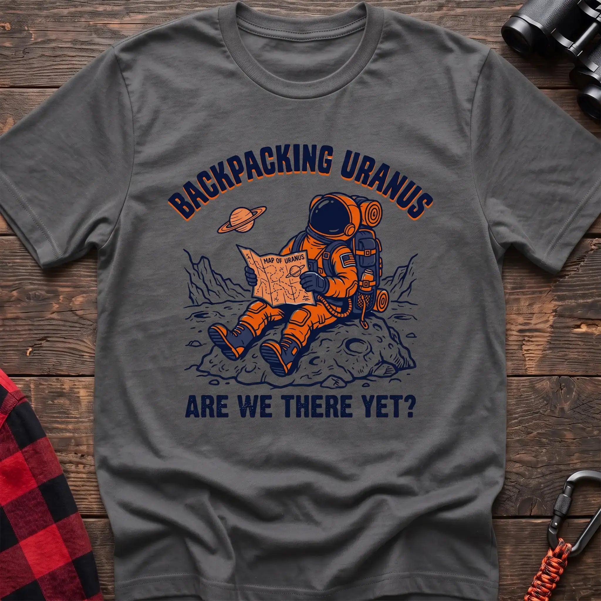 Graphite heather t-shirt with astronaut sitting on a rock reading a Map of Uranus and the text Backpacking Uranus Are We There Yet