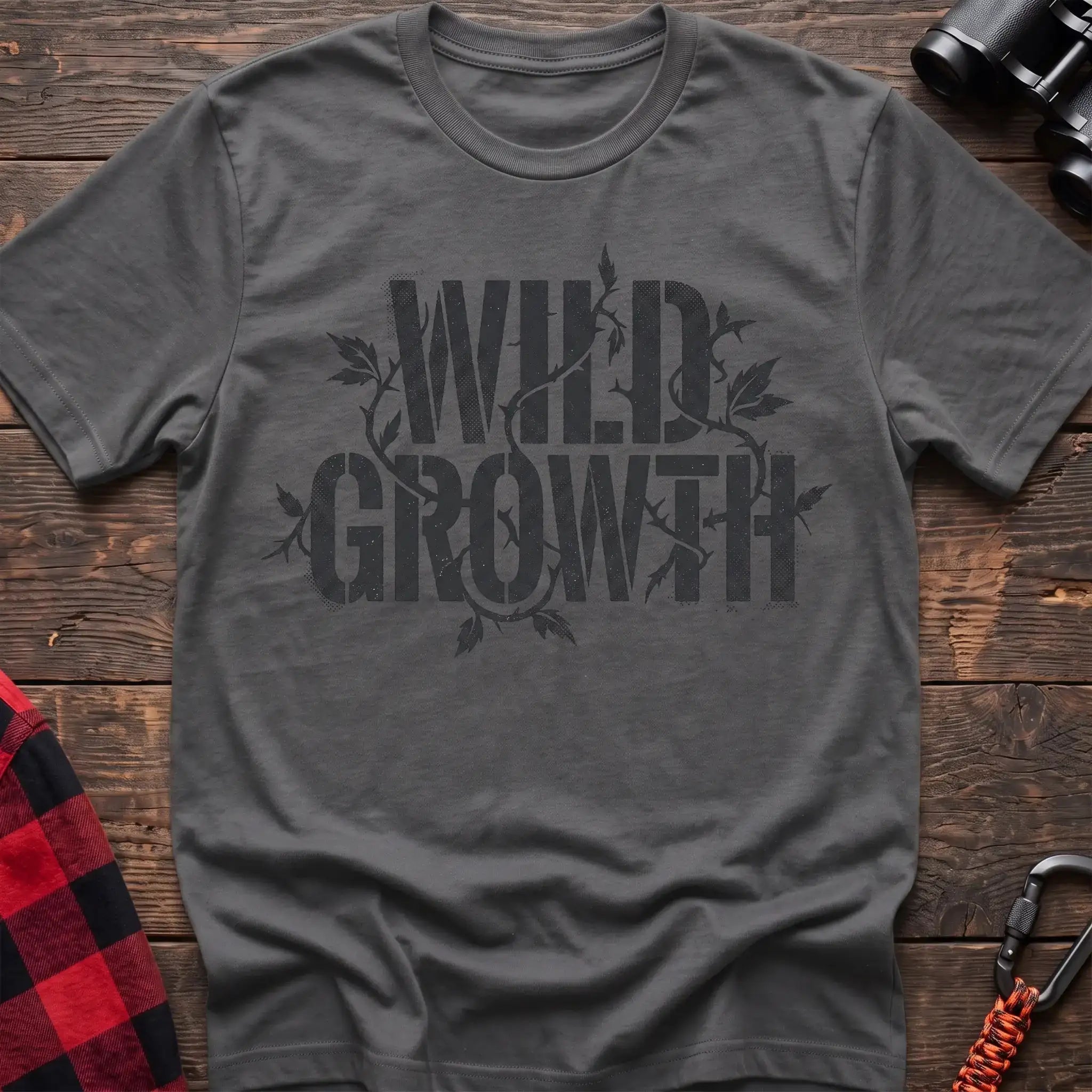 Graphite heather t-shirt with dark text reading Wild Growth intertwined with thorny vines and leaves