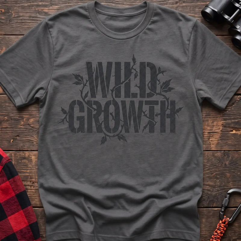 Graphite heather t-shirt with dark text reading Wild Growth intertwined with thorny vines and leaves