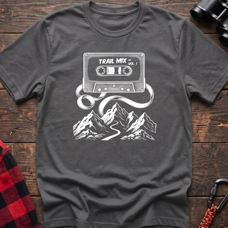Graphite heather t-shirt with white cassette tape graphic labeled Trail Mix Vol. 1, with tape unspooling into a trail through mountains