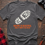 Graphite heather t-shirt with white boot print graphic featuring a skull and pine trees, and orange text reading Nature Is Beautiful And It Wants You Dead