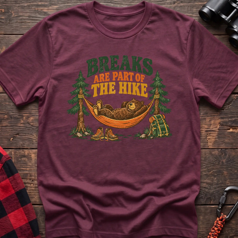 Heather maroon cotton t-shirt with a bear in a hammock graphic and Breaks Are Part of the Hike text on rustic wood