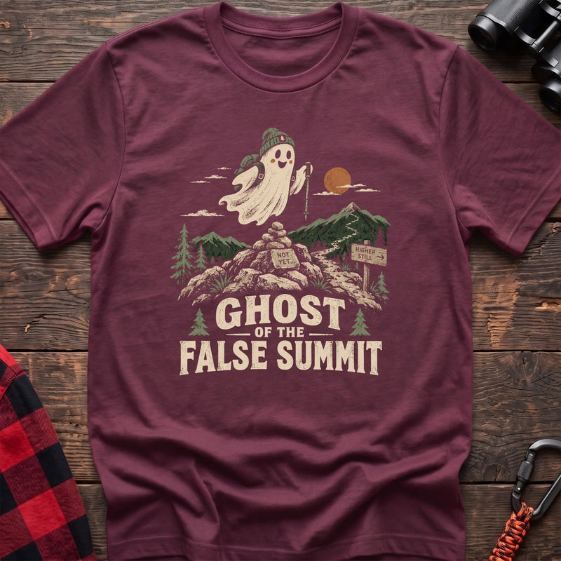 Heather maroon cotton t-shirt with a hiking ghost graphic and Ghost of the False Summit text on rustic wood