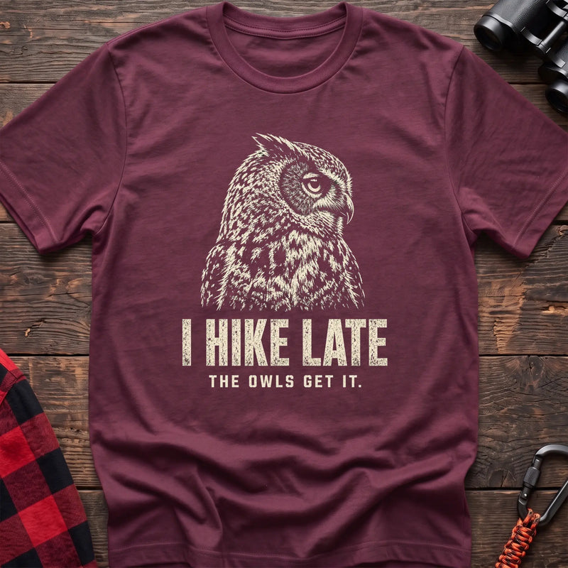 Heather maroon cotton t-shirt with an owl graphic and I Hike Late The Owls Get It text on rustic wood