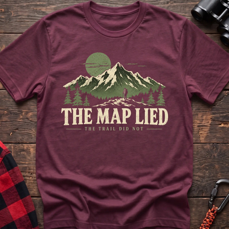 Heather maroon cotton t-shirt with a hiker and mountain graphic and The Map Lied The Trail Did Not text on rustic wood