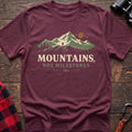 Heather maroon cotton t-shirt with a hiker and mountain graphic and Mountains Not Milestones text on rustic wood