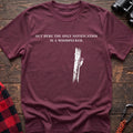 Heather maroon cotton t-shirt with a woodpecker graphic and Out Here the Only Notification Is a Woodpecker text on rustic wood