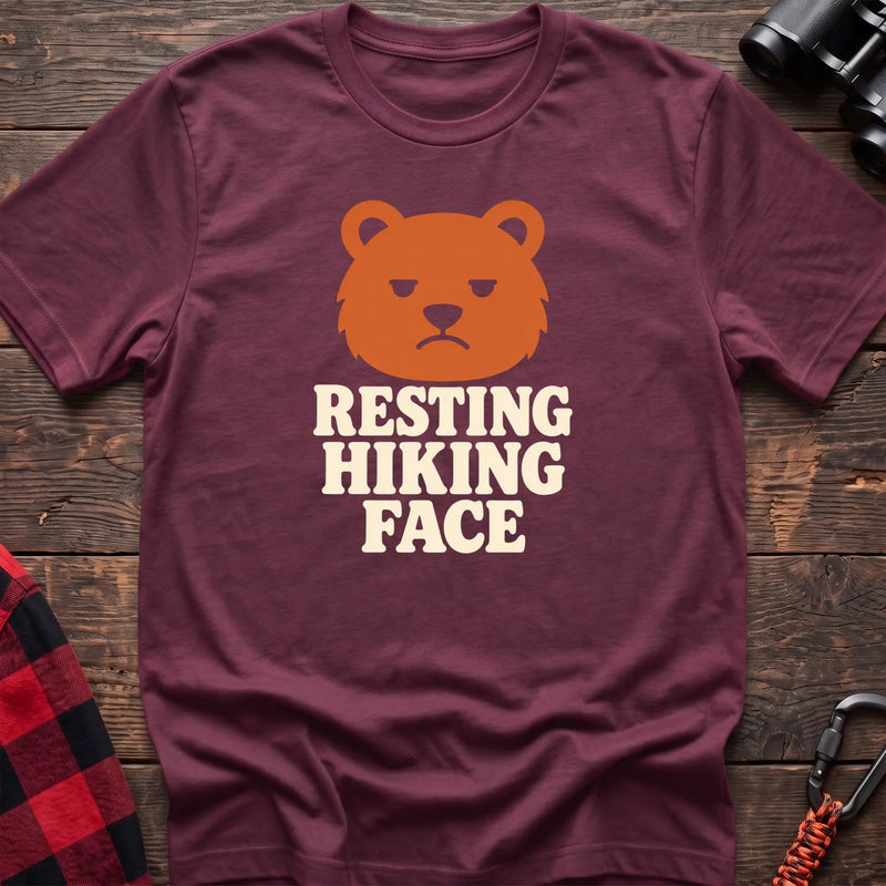 Heather maroon cotton t-shirt with a grumpy bear graphic and Resting Hiking Face text on rustic wood