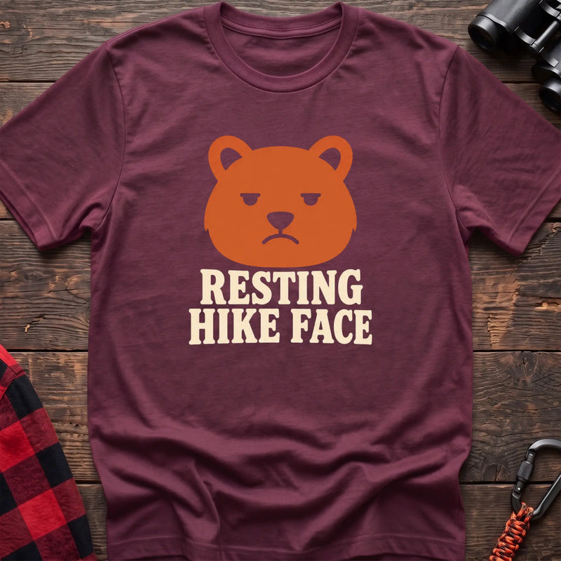 Heather maroon cotton t-shirt with a grumpy bear graphic and Resting Hike Face text on rustic wood