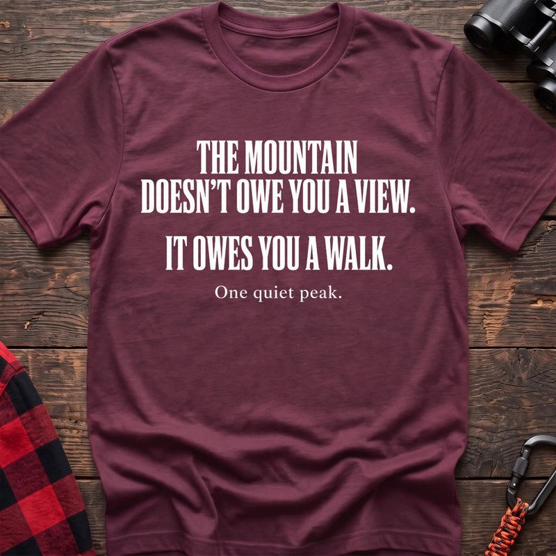 Heather maroon cotton t-shirt with The Mountain Doesn’t Owe You a View It Owes You a Walk text on rustic wood