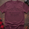 Heather maroon cotton hiking t-shirt with simple mountain line drawing and "The mountains are calling and I must go" quote