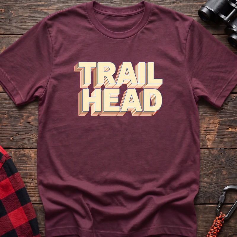 Black cotton t-shirt with retro stacked Trail Head text on rustic wood