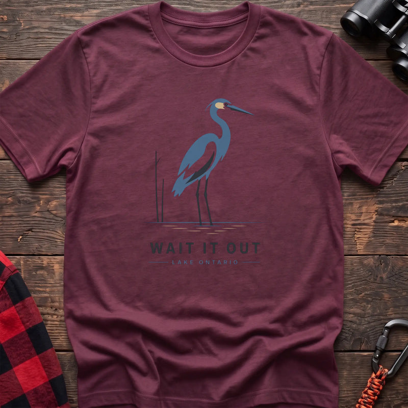 Heather maroon hiking t-shirt with a blue heron graphic and the text “Wait It Out Lake Ontario”