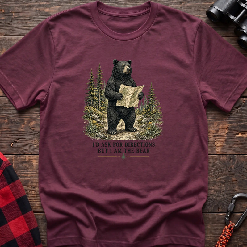 Heather maroon cotton t-shirt with a bear holding a map graphic and I’d Ask for Directions But I Am the Bear text on rustic wood