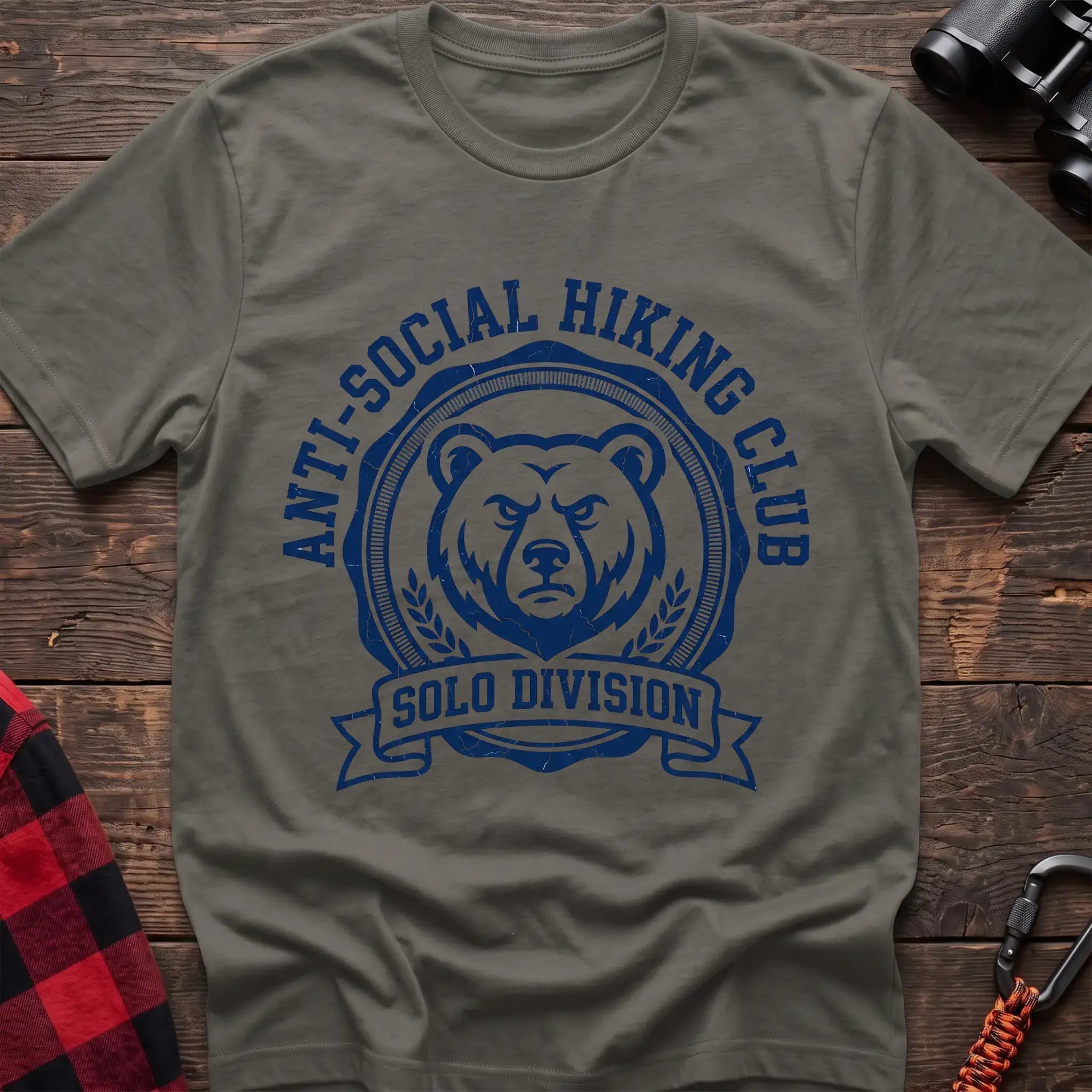 Heather military green t-shirt with circular badge of a serious bear face reading Anti-Social Hiking Club Solo Division