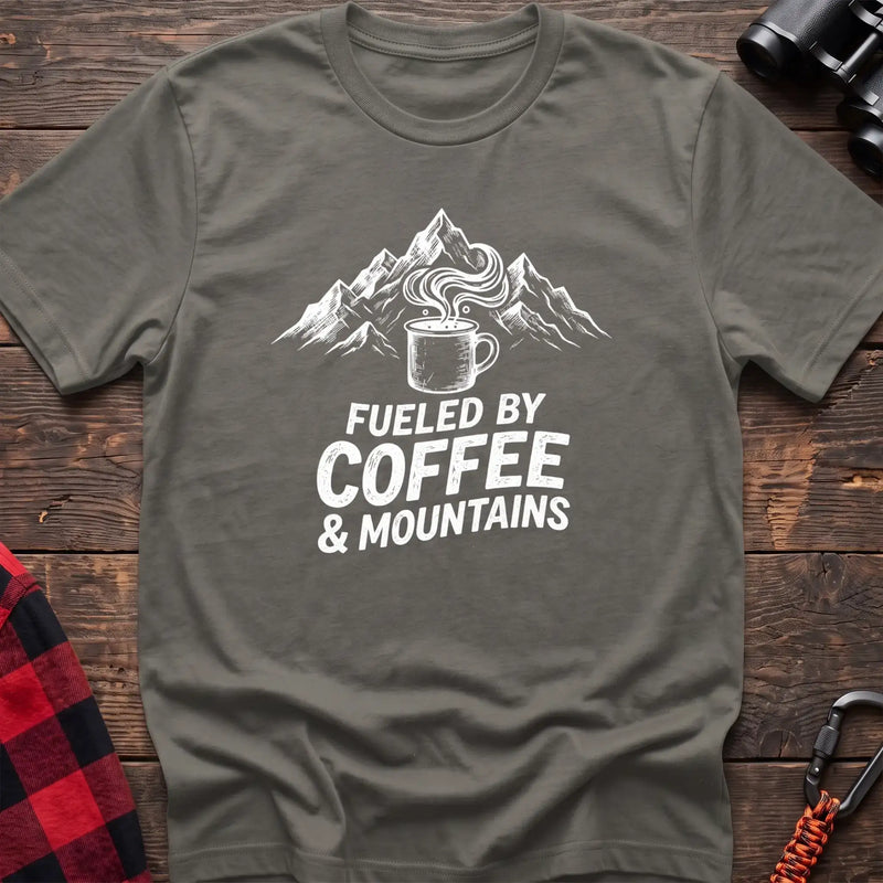Heather military green t-shirt with white graphic of a steaming coffee mug in front of mountains and the text Fueled by Coffee & Mountains