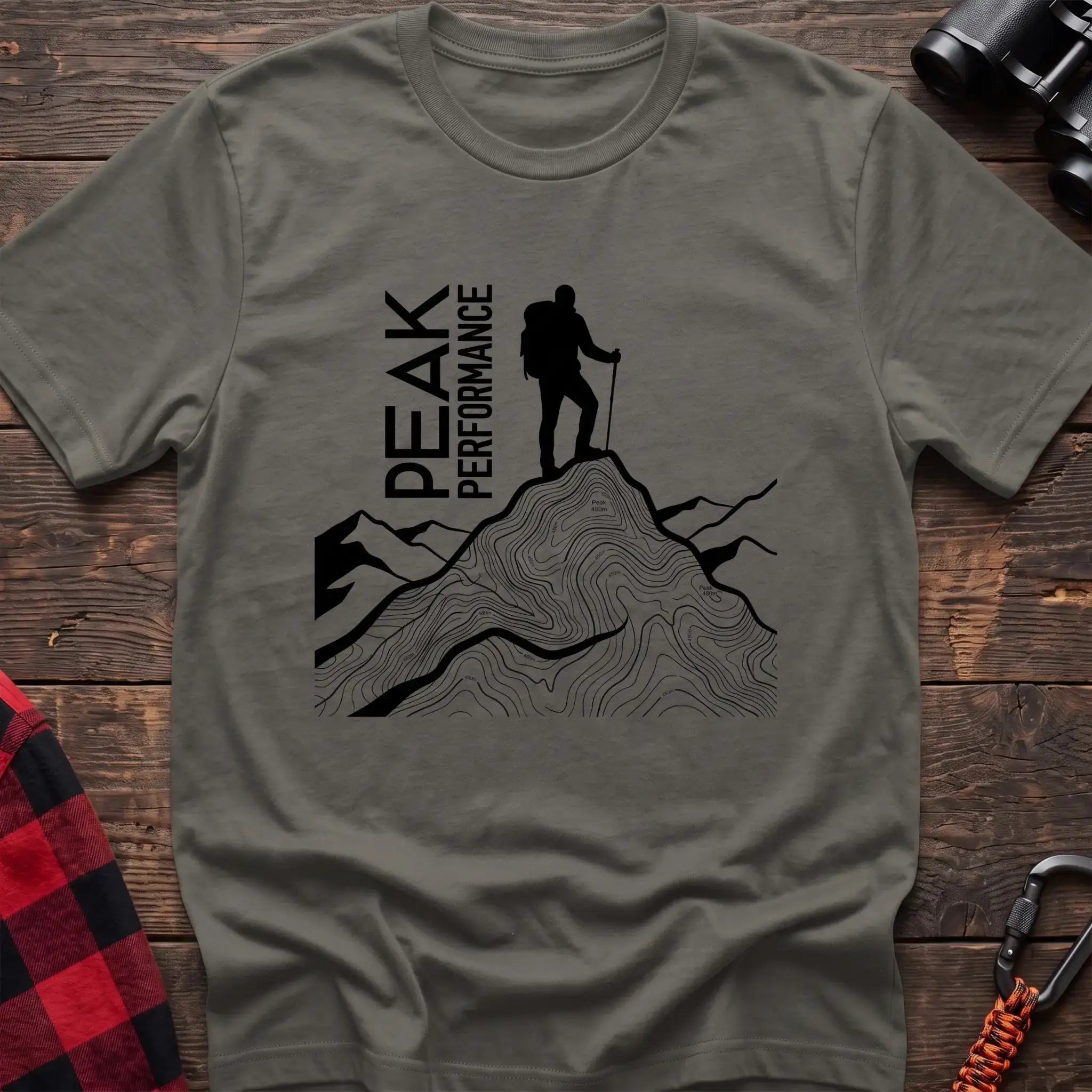Heather military green t-shirt with hiker silhouette on a topographic mountain peak and the text Peak Performance