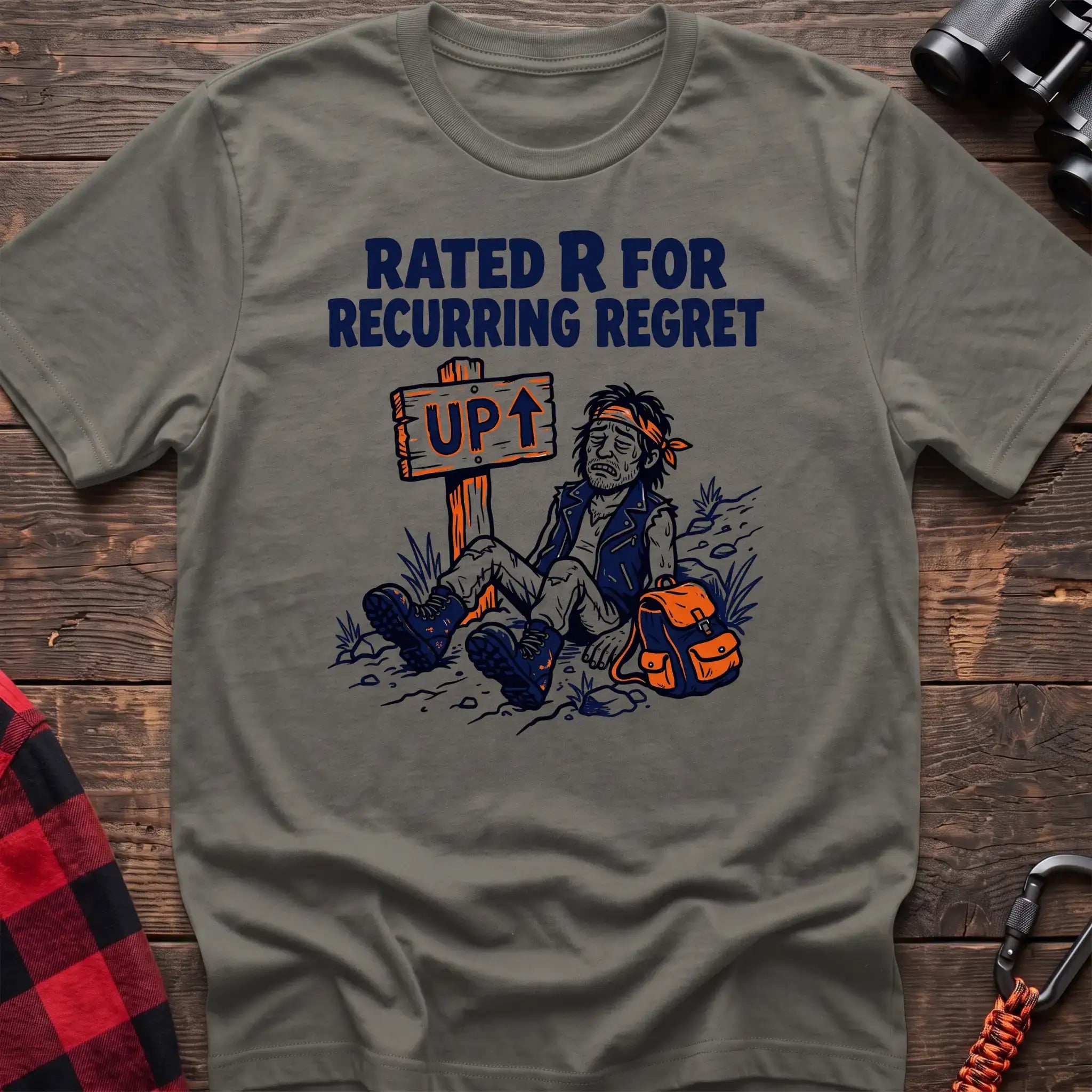 Heather military green t-shirt with illustration of an exhausted hiker sitting by an UP trail sign and the text Rated R for Recurring Regret