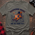 Heather military green t-shirt with astronaut sitting on a rock reading a Map of Uranus and the text Backpacking Uranus Are We There Yet