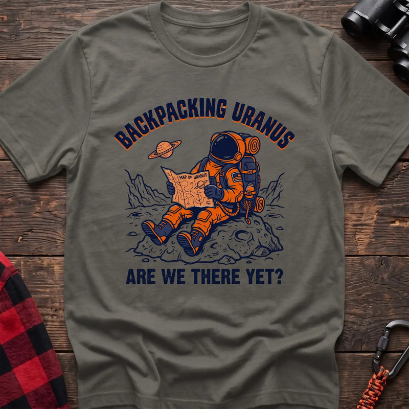 Heather military green t-shirt with astronaut sitting on a rock reading a Map of Uranus and the text Backpacking Uranus Are We There Yet