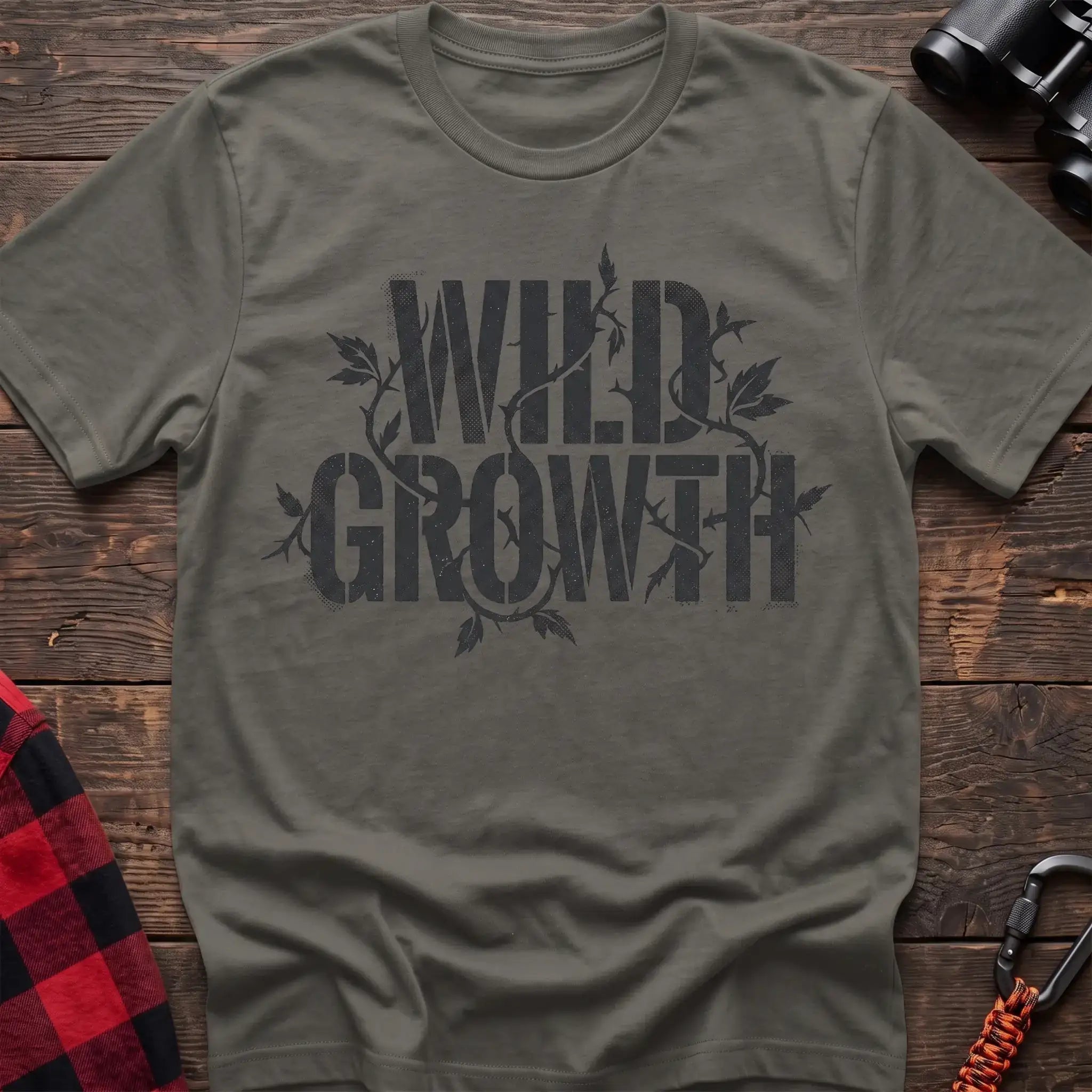 Heather military green t-shirt with dark text reading Wild Growth intertwined with thorny vines and leaves