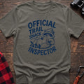 Heather military green t-shirt with cartoon raccoon holding a snack and the text Official Trail Snack Inspector
