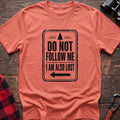 Heather orange hiking t-shirt with vintage trail sign reading Do Not Follow Me I Am Also Lost and a pine tree graphic