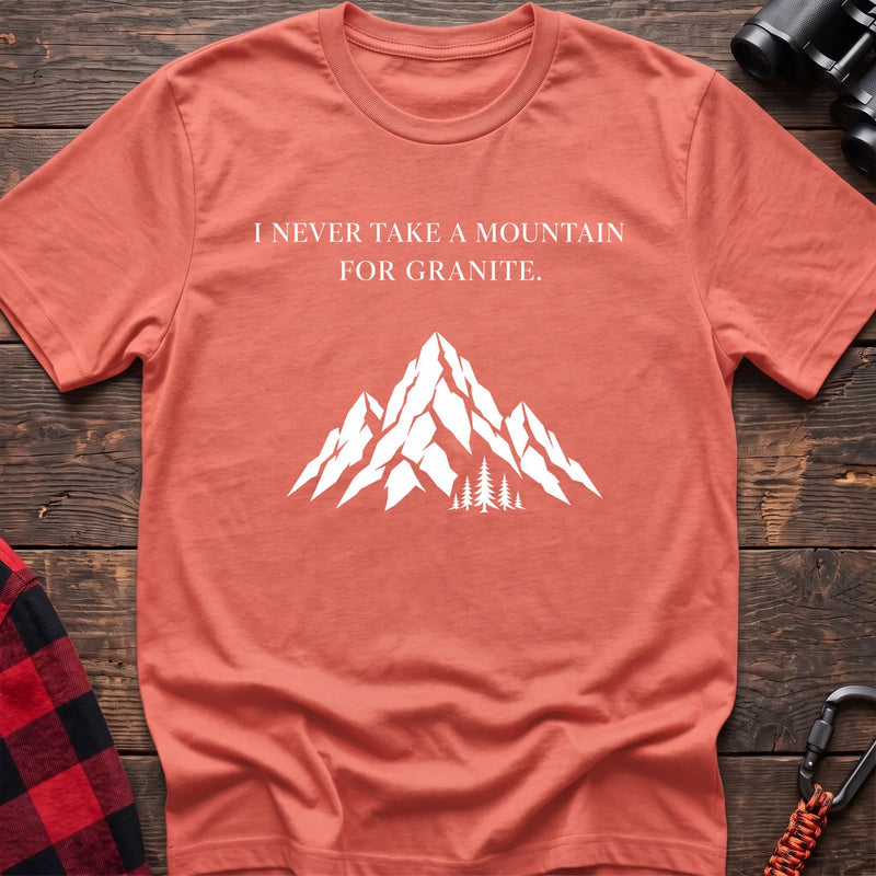 Heather orange cotton t-shirt with a mountain graphic and I Never Take a Mountain for Granite text on rustic wood