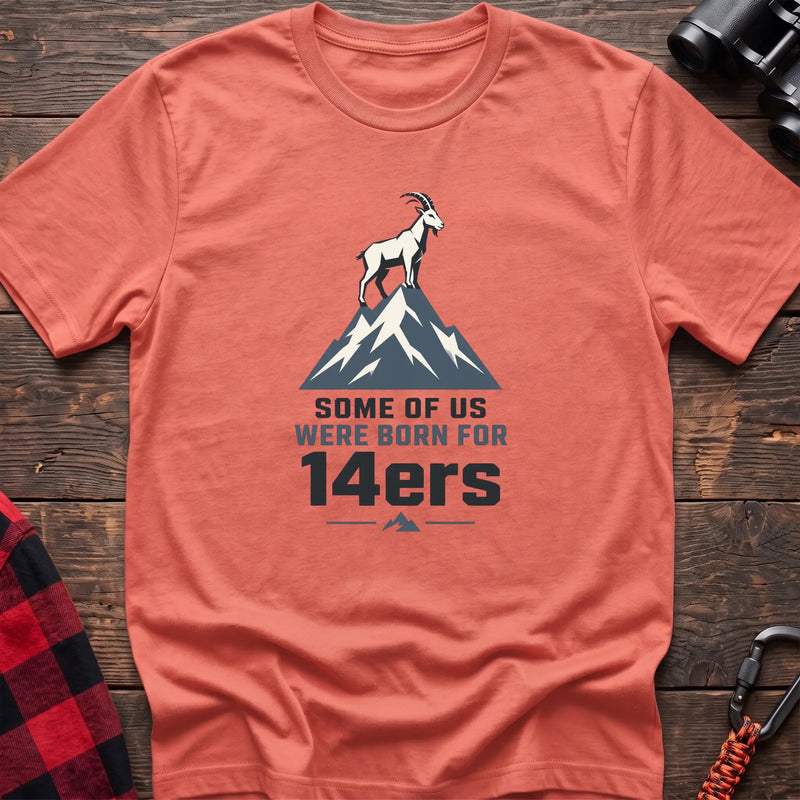 Heather orange hiking t-shirt with a mountain goat on a peak and the text “Some of Us Were Born for 14ers”