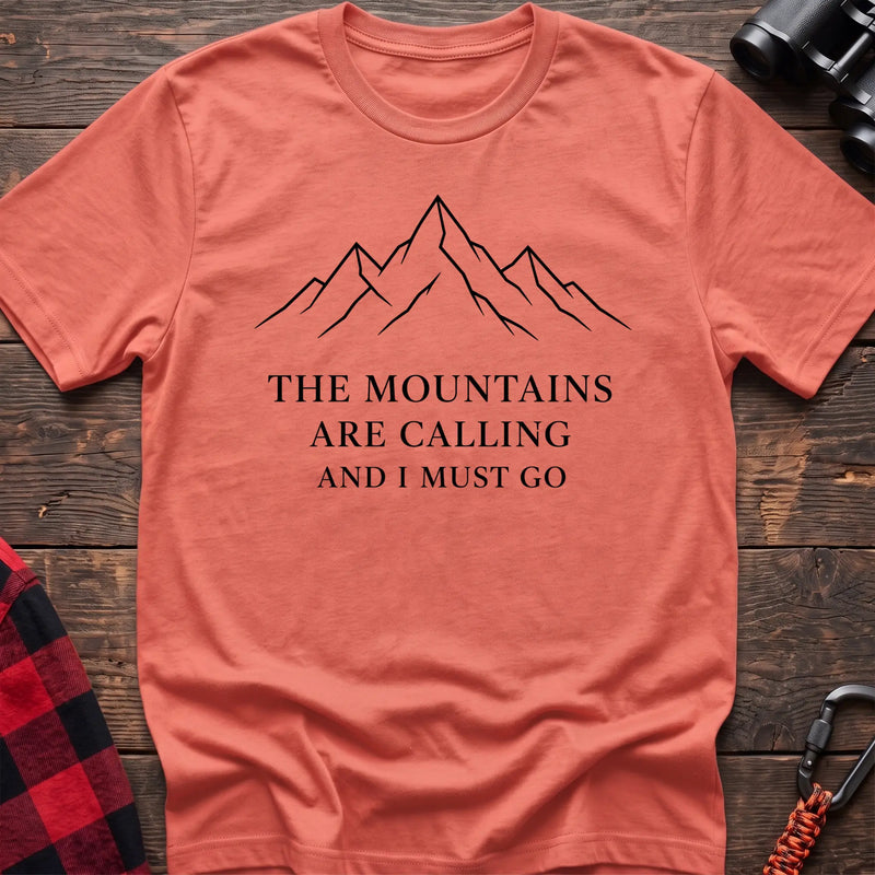 Heather orange cotton hiking t-shirt with simple mountain line drawing and "The mountains are calling and I must go" quote
