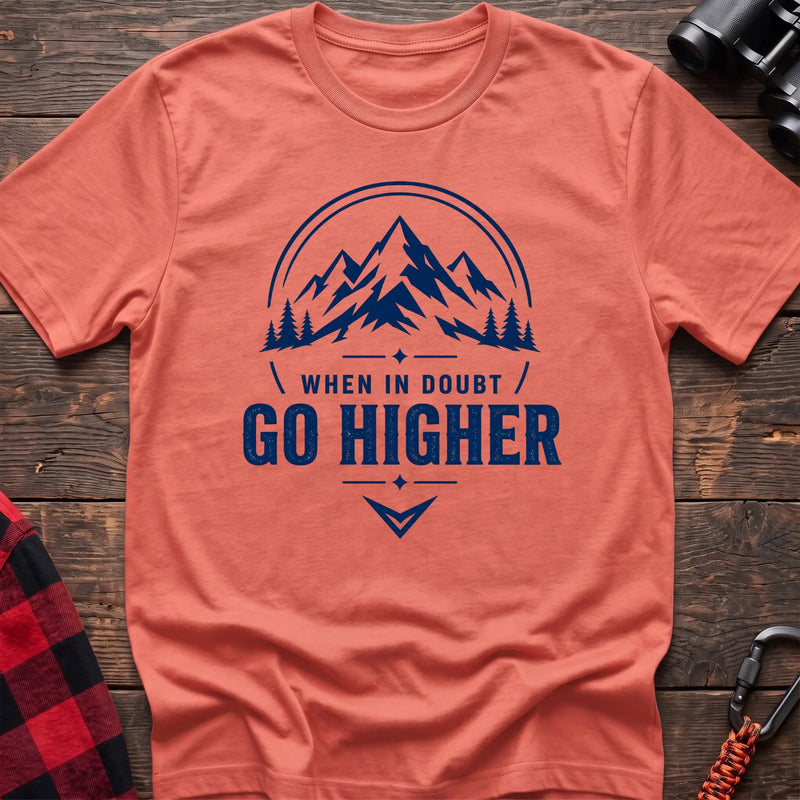 Heather orange cotton hiking t-shirt with navy mountain and pine tree graphic and "When in doubt go higher" quote