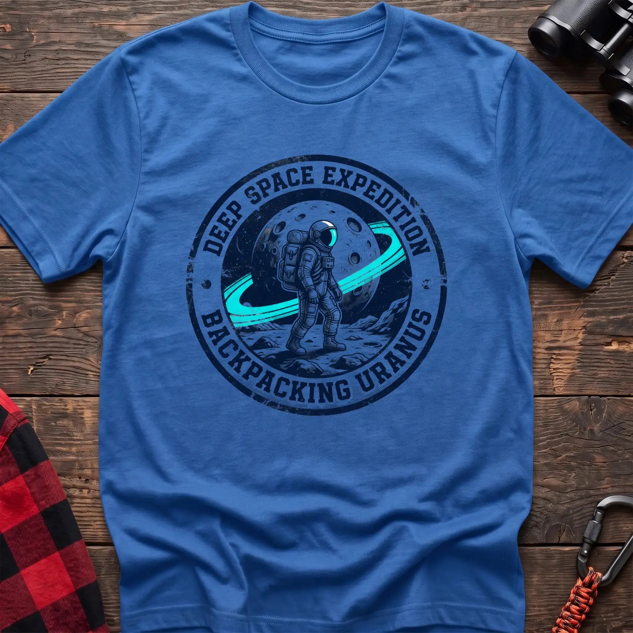 Heather royal t-shirt with circular badge graphic of an astronaut backpacking on Uranus, reading Deep Space Expedition Backpacking Uranus