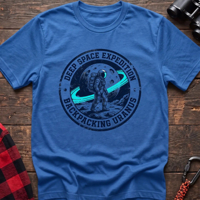 Heather royal t-shirt with circular badge graphic of an astronaut backpacking on Uranus, reading Deep Space Expedition Backpacking Uranus