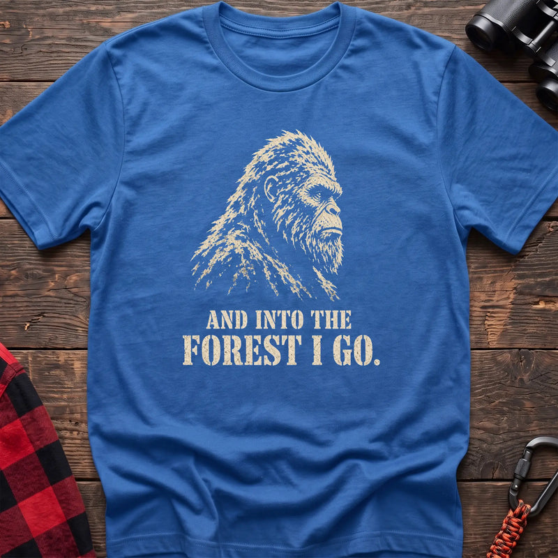 Heather royal cotton t-shirt with a Bigfoot graphic and And Into the Forest I Go text on rustic wood