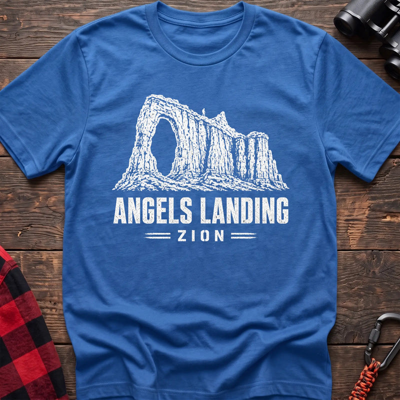 Heather royal cotton t-shirt with a canyon graphic and Angels Landing Zion text on rustic wood