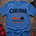 Heather royal cotton t-shirt with a village and trail graphic and Carlsbad Village Start with Coffee End with Dirt text on rustic wood