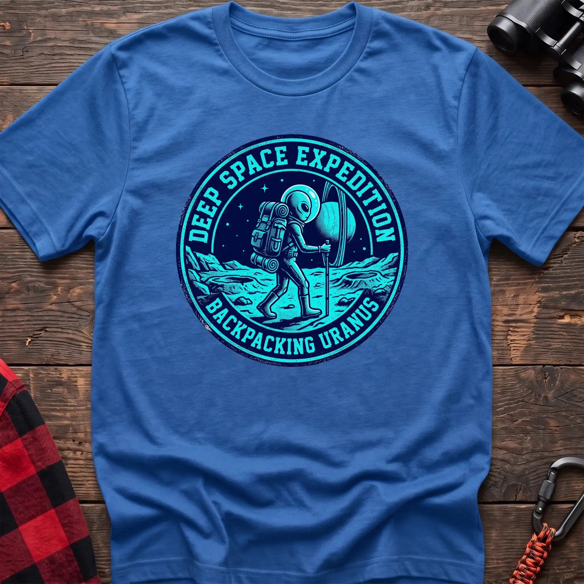 Heather royal t-shirt with circular badge graphic of an alien backpacking on Uranus, reading Deep Space Expedition Backpacking Uranus