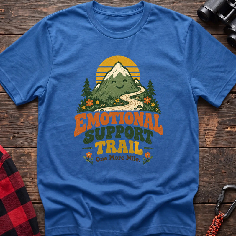Heather royal cotton t-shirt with a smiling mountain and trail graphic and Emotional Support Trail text on rustic wood