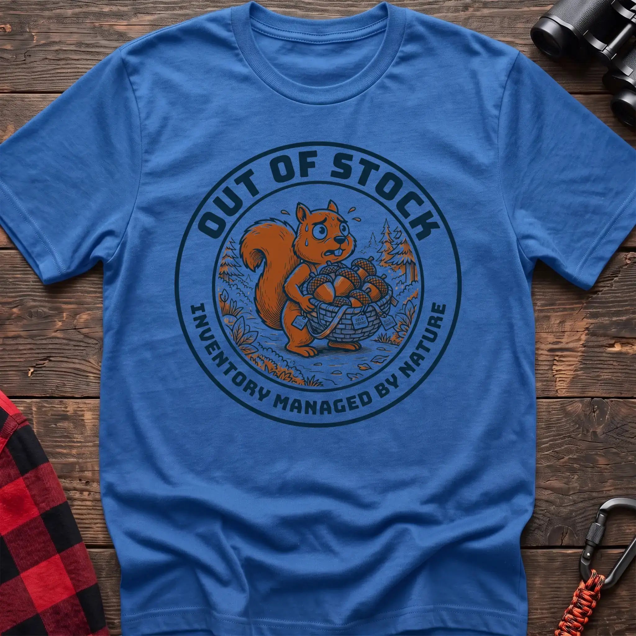 Heather royal t-shirt with circular graphic of a stressed squirrel holding a basket of acorns, reading Out of Stock Inventory Managed by Nature