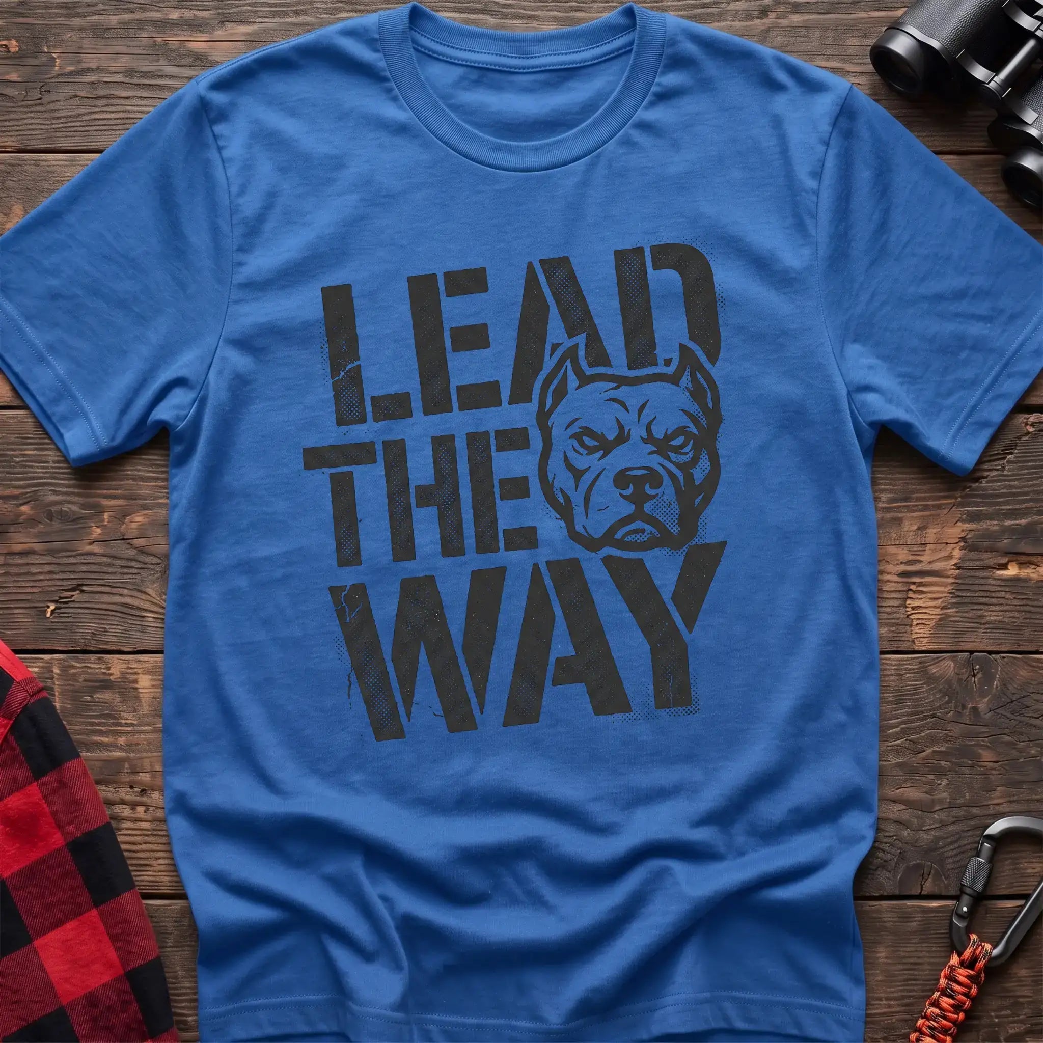 Heather royal t-shirt with a distressed graphic of a stern pit bull head integrated into the bold text “LEAD THE WAY,” laid flat on a wooden surface.