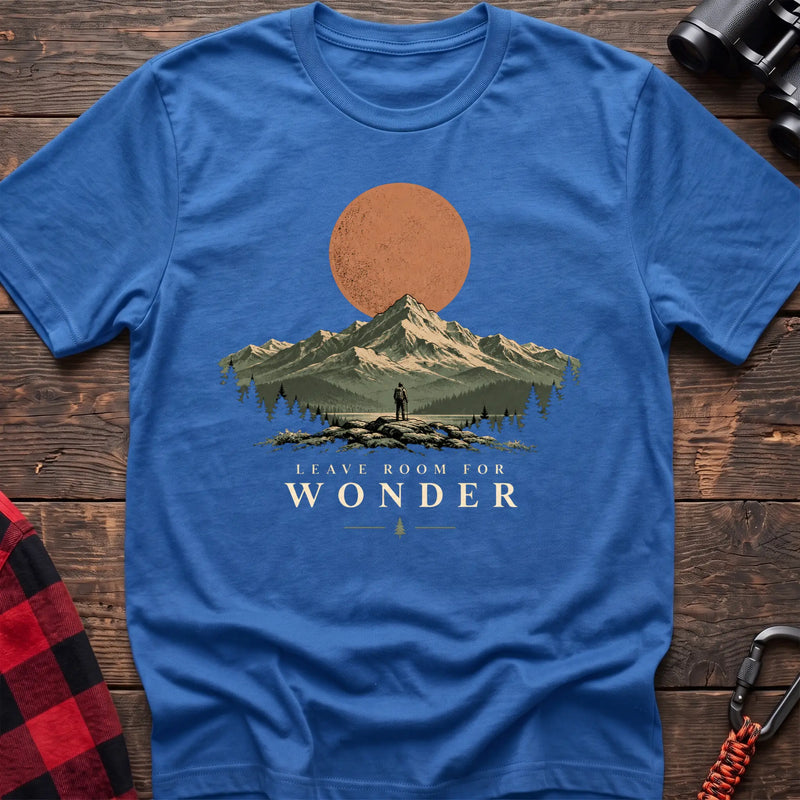 Heather royal cotton t-shirt with a hiker and mountain sunset graphic and Leave Room for Wonder text on rustic wood