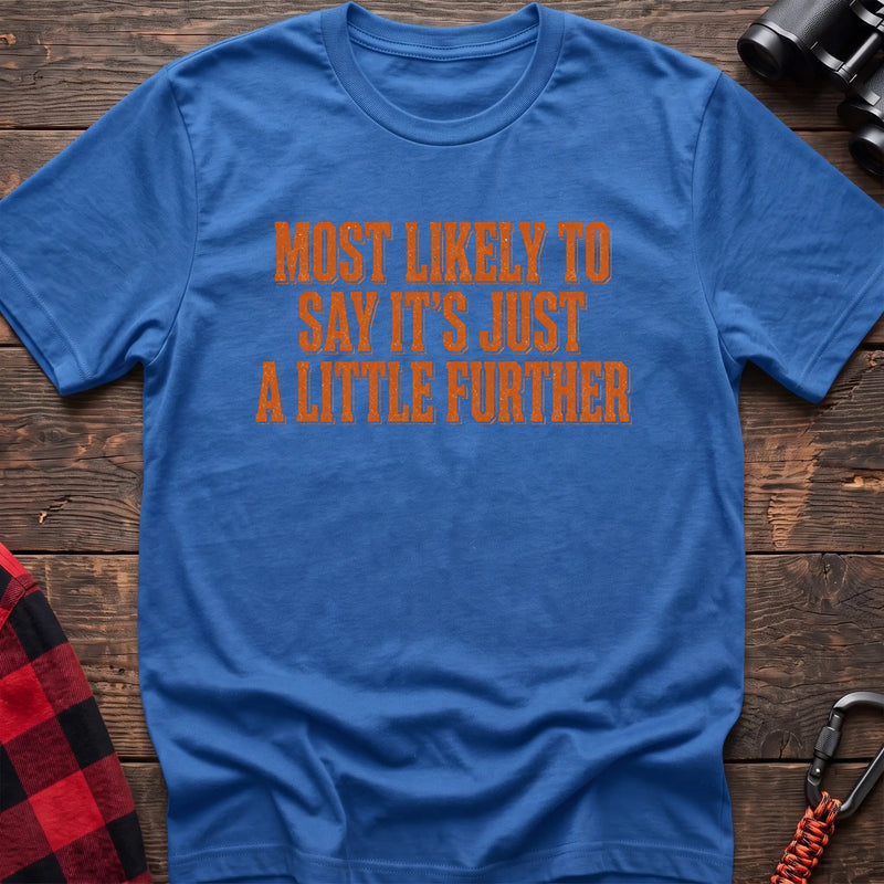 Heather royal cotton t-shirt with Most Likely to Say It’s Just a Little Further text on rustic wood