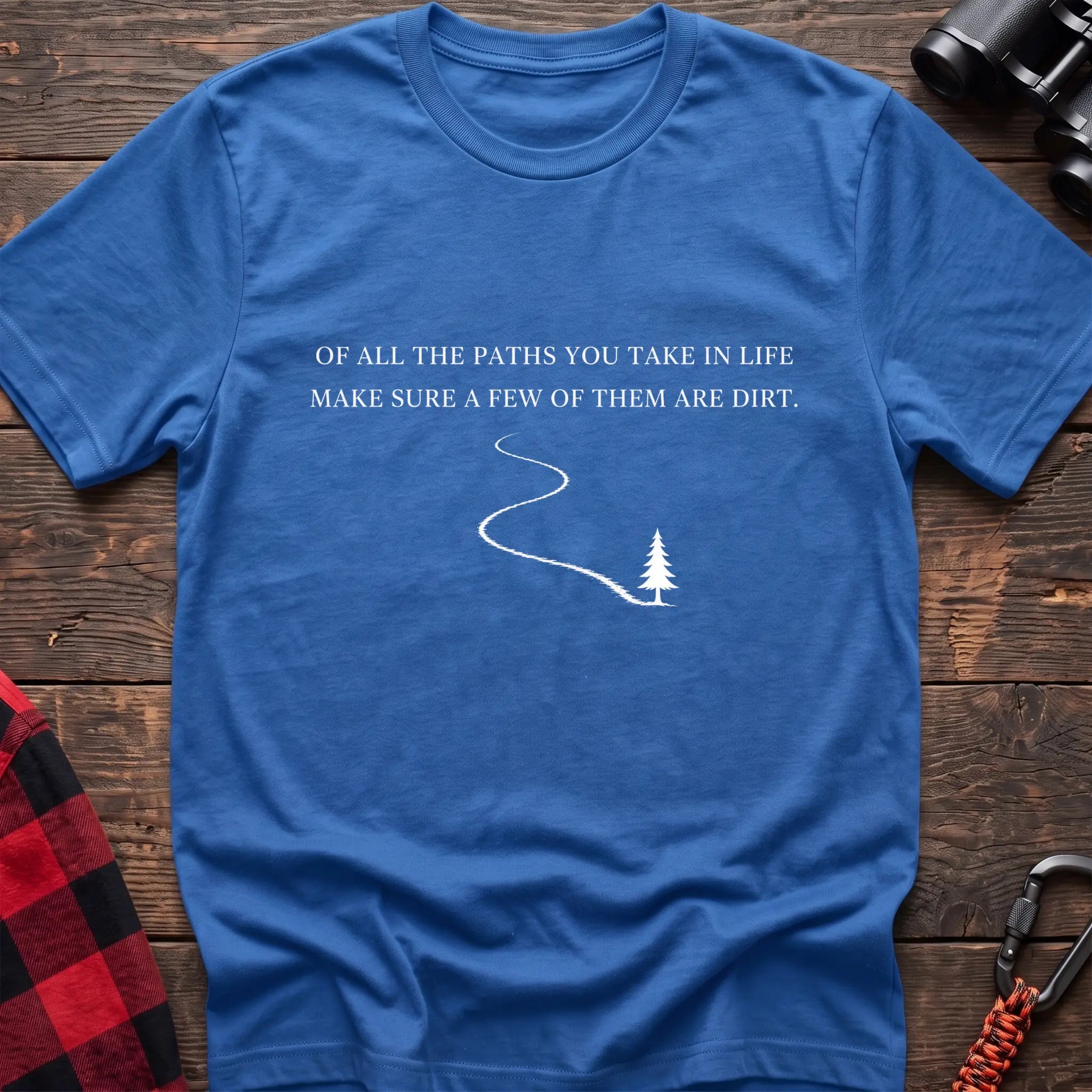 Heather royal cotton hiking t-shirt with white quote "Of all the paths you take in life make sure a few of them are dirt" and winding dirt path to pine tree graphic