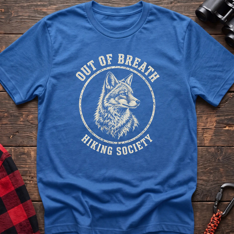 Heather royal cotton t-shirt with a wolf graphic and Out of Breath Hiking Society text on rustic wood