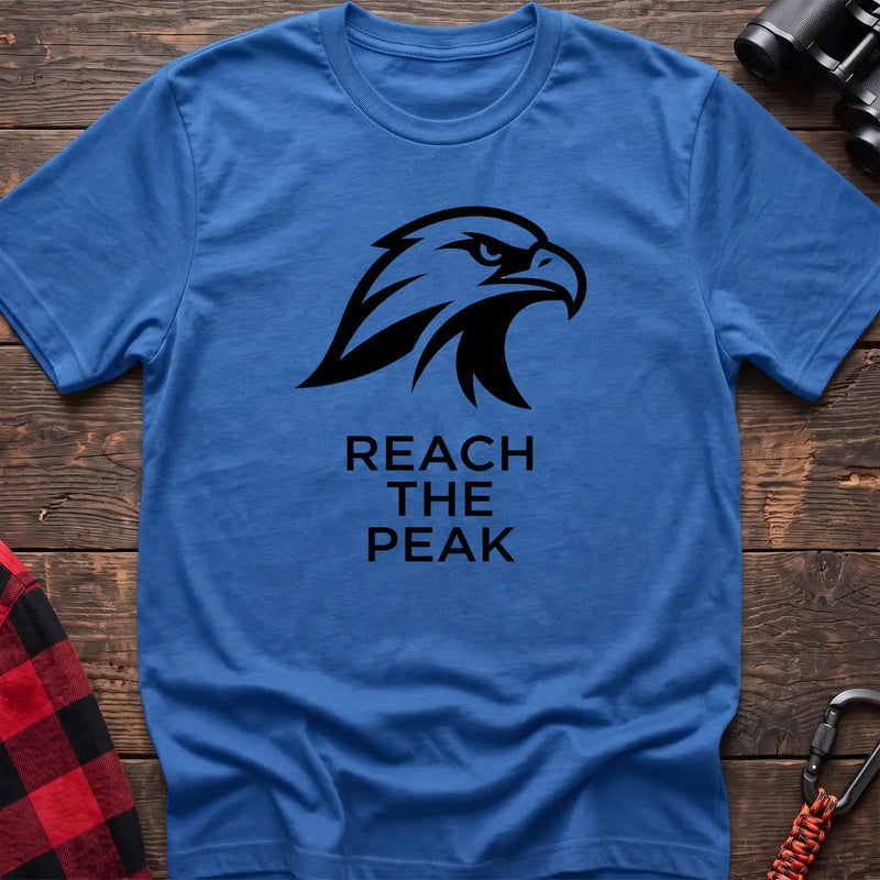 Heather royal crew-neck t-shirt with a black stylized eagle head logo and the text “REACH THE PEAK” printed on the front