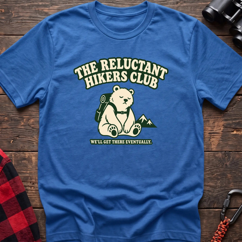 Heather royal cotton t-shirt with a sitting backpack bear graphic and The Reluctant Hikers Club text on rustic wood