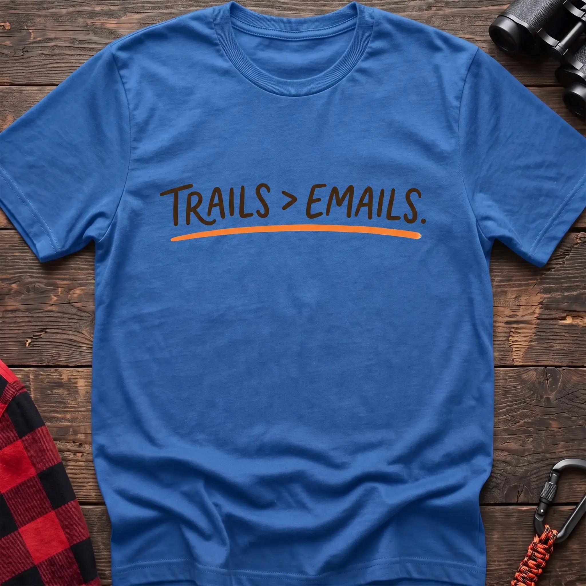 Heather royal t-shirt with brown handwritten-style text reading Trails greater than Emails and an orange underline